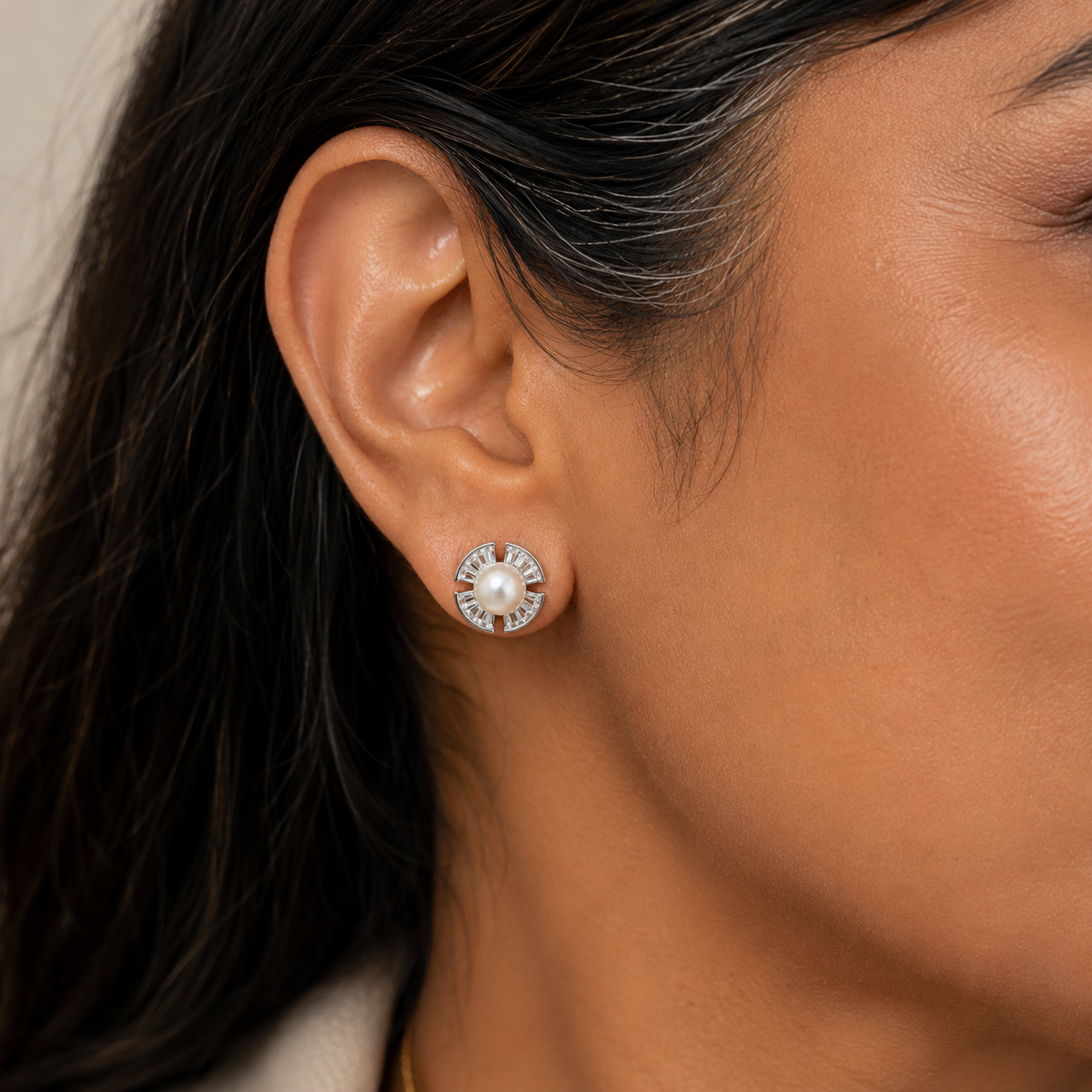 40+ Indian woman wearing 925 sterling silver freshwater pearl stud earrings on her right ear.