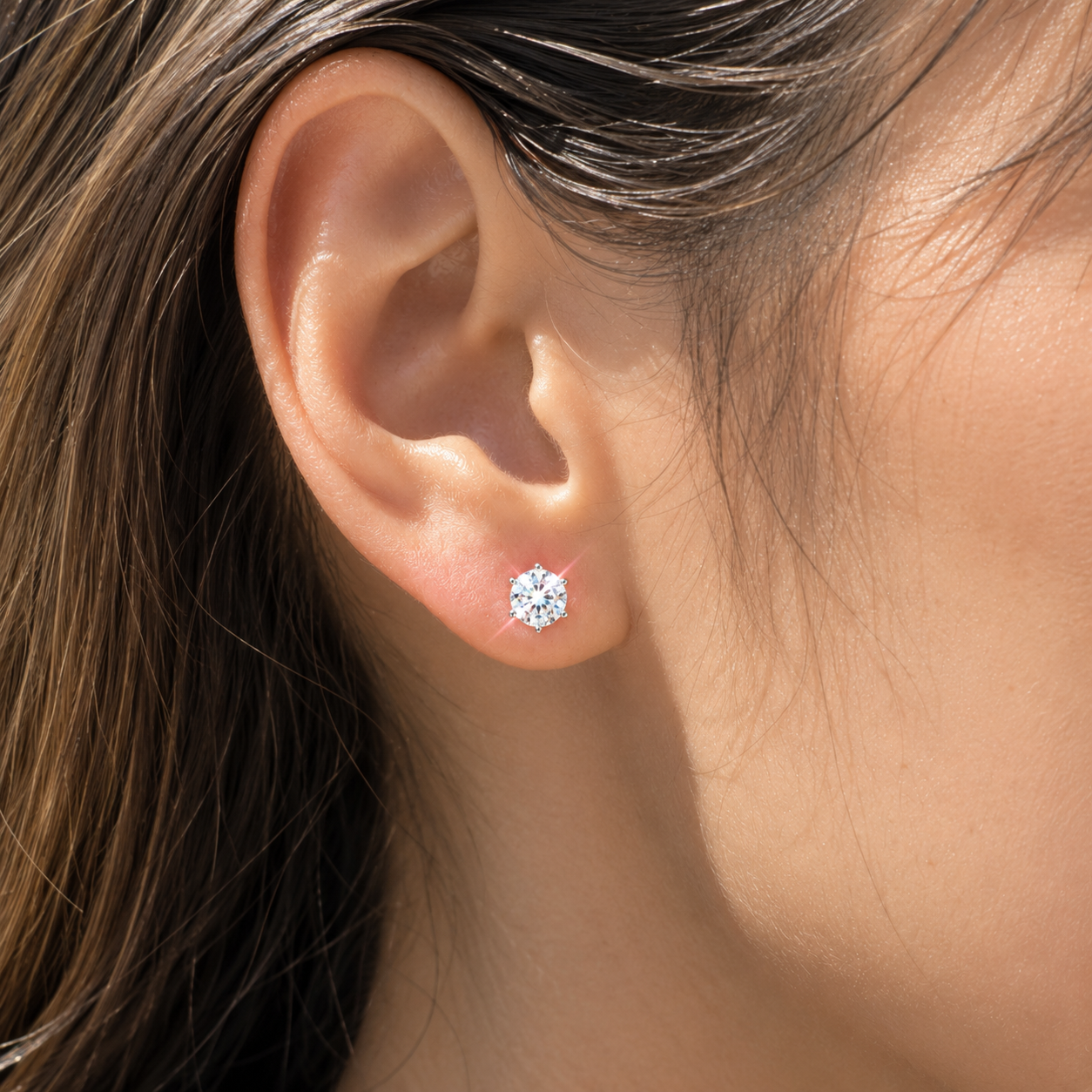 925 sterling silver six-prong moissanite stud earring worn on right ear