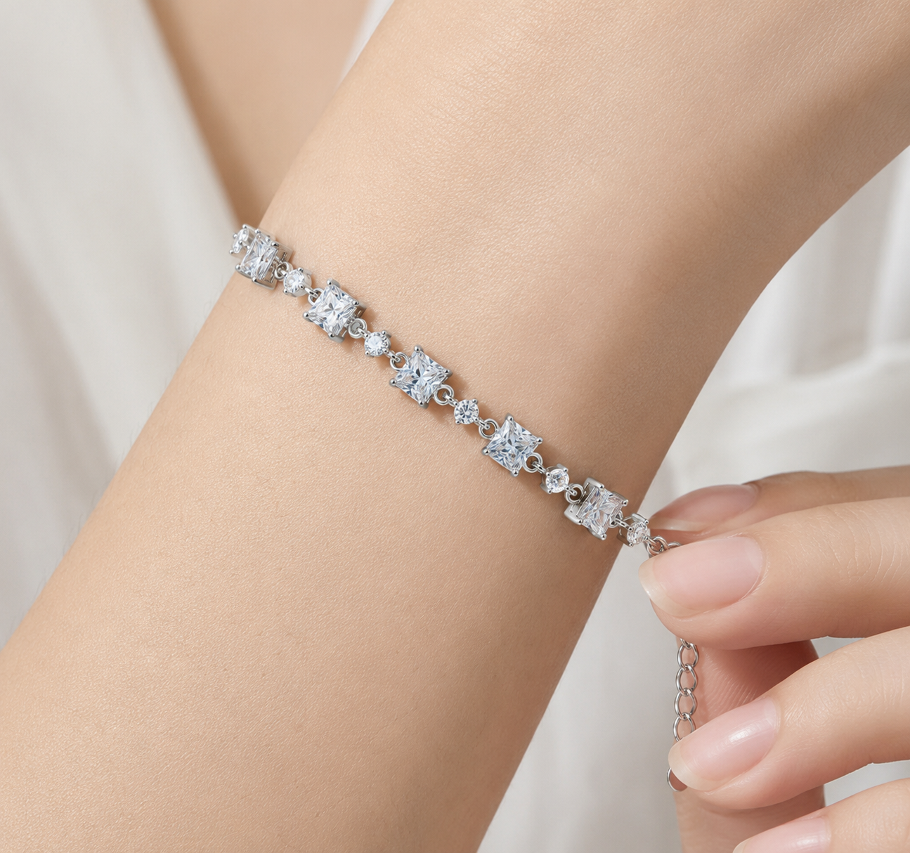 Close-up of 925 sterling silver square and round cubic zirconia bracelet worn on wrist
