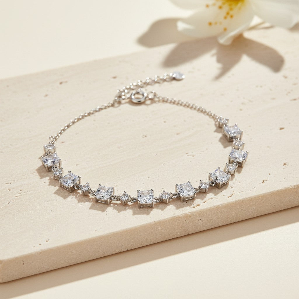 925 sterling silver square cubic zirconia bracelet displayed on a warm neutral stone surface