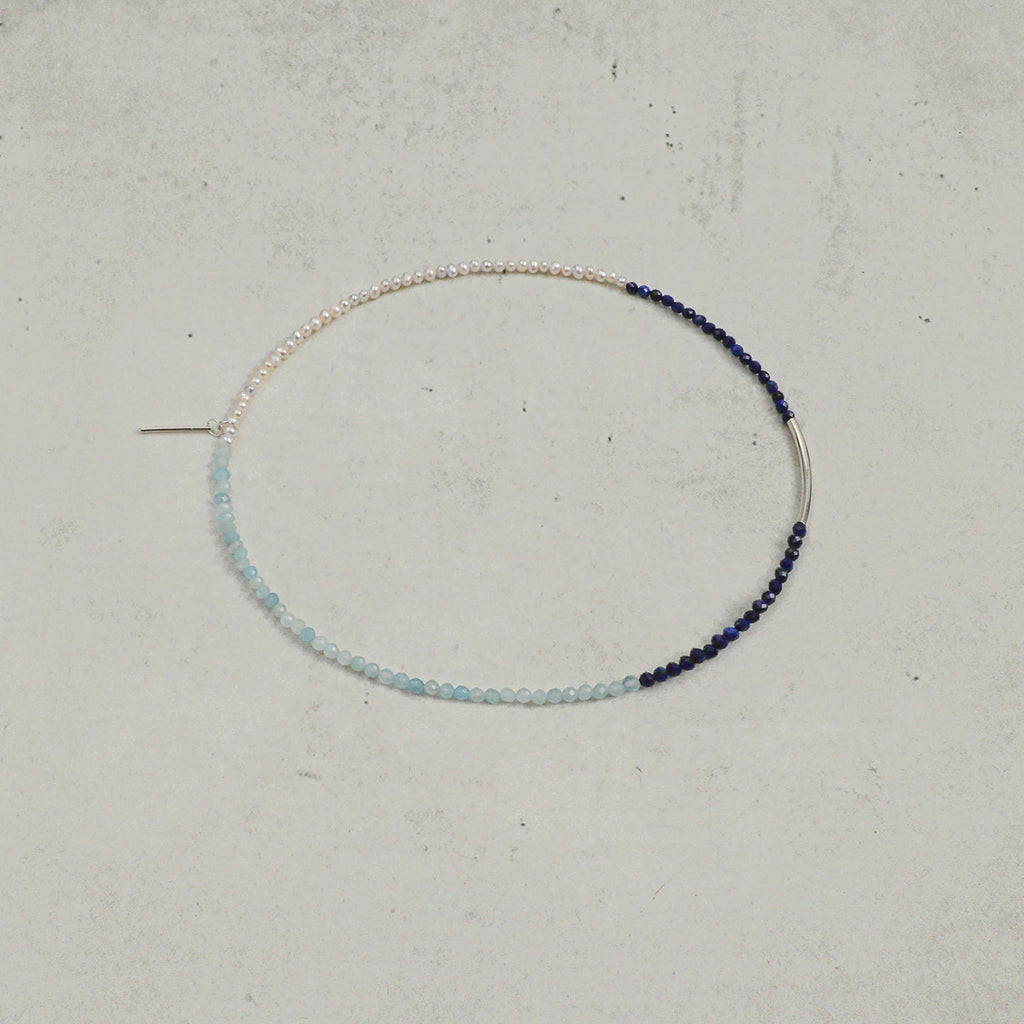 Open view of aquamarine, lapis lazuli and freshwater pearl layered bracelet with silver accent