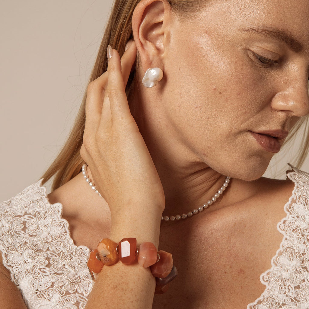 Carnelian and freshwater pearl statement bracelet worn on wrist