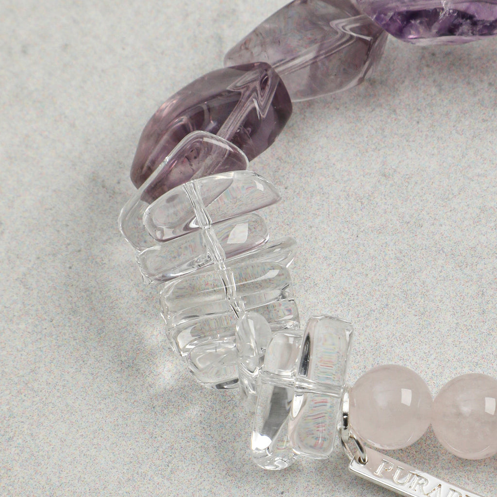 Close-up of clear quartz gemstone accents on handmade rose quartz and amethyst bracelet