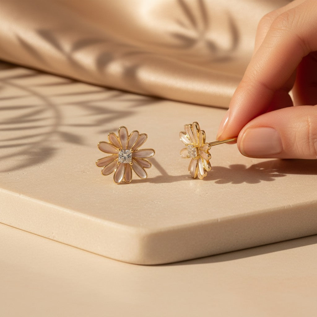 Daisy Bloom stud earrings in 925 sterling silver with 14K gold plating displayed on a warm neutral surface