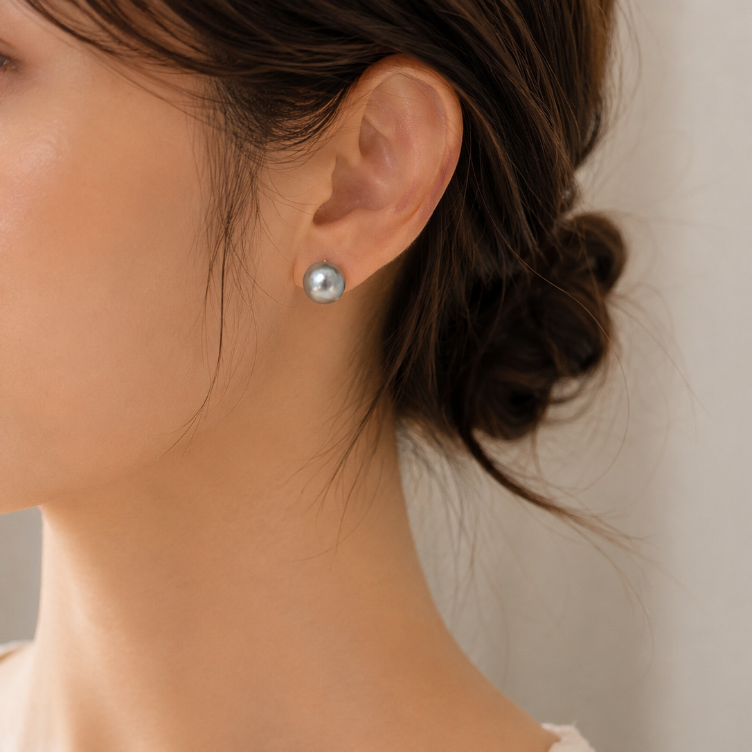 Grey baroque freshwater pearl stud earring worn on left ear