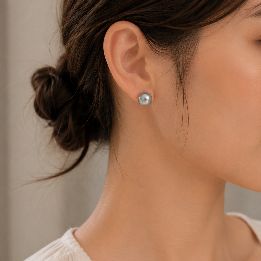 Grey baroque freshwater pearl stud earring worn on right ear