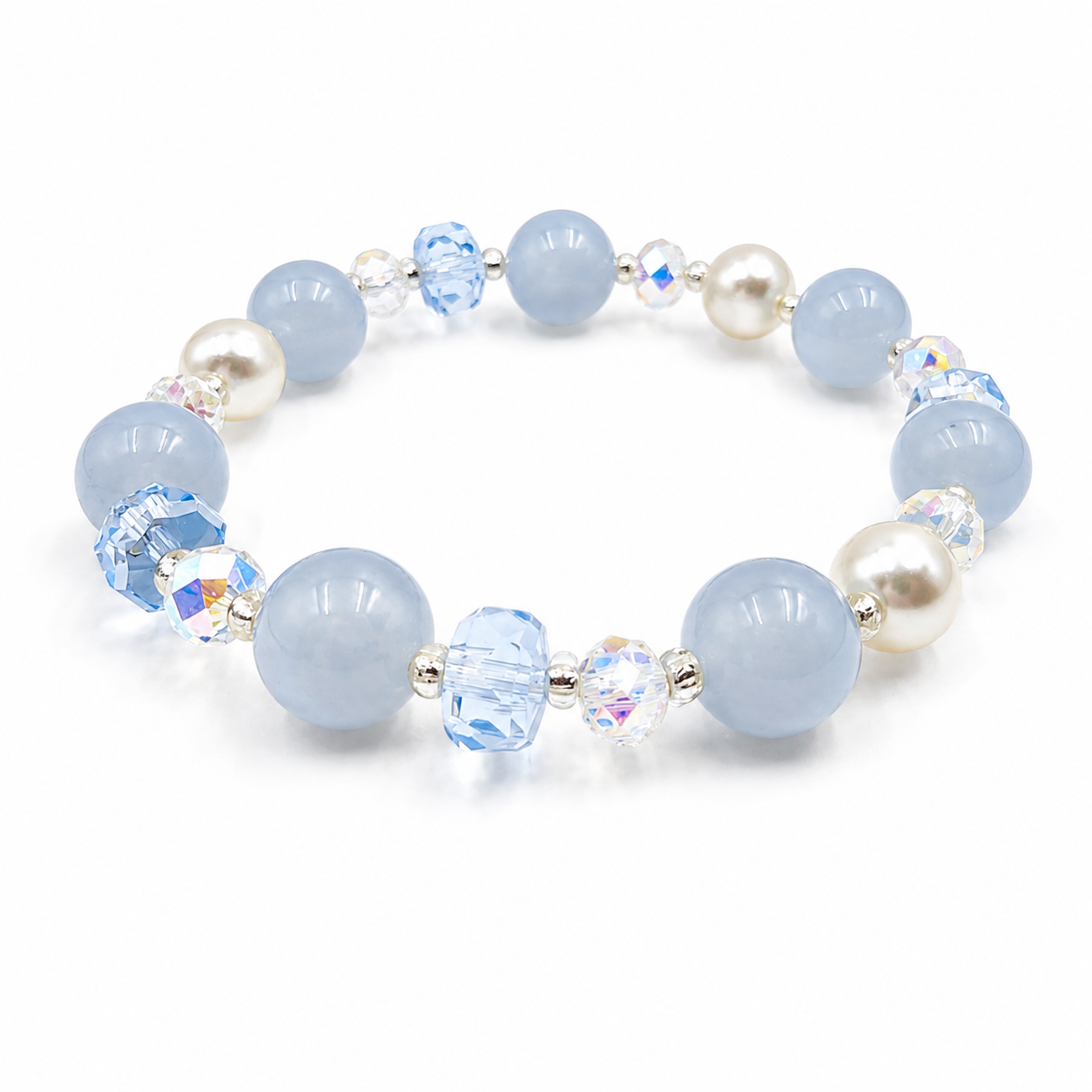 Angled view of a handmade bracelet featuring 10mm natural aquamarine beads, 8mm genuine freshwater pearls, 8mm blue faceted crystal beads, 6mm aurora crystal accent beads and silver-tone spacer beads on a white background.