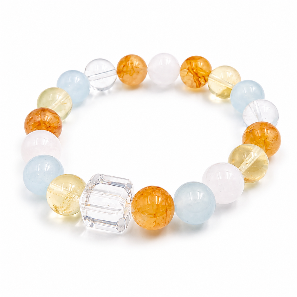 Handmade bracelet featuring 10mm natural yellow flower quartz, aquamarine, rose quartz, citrine and clear quartz beads with a 12mm faceted clear quartz cube bead on a white background.