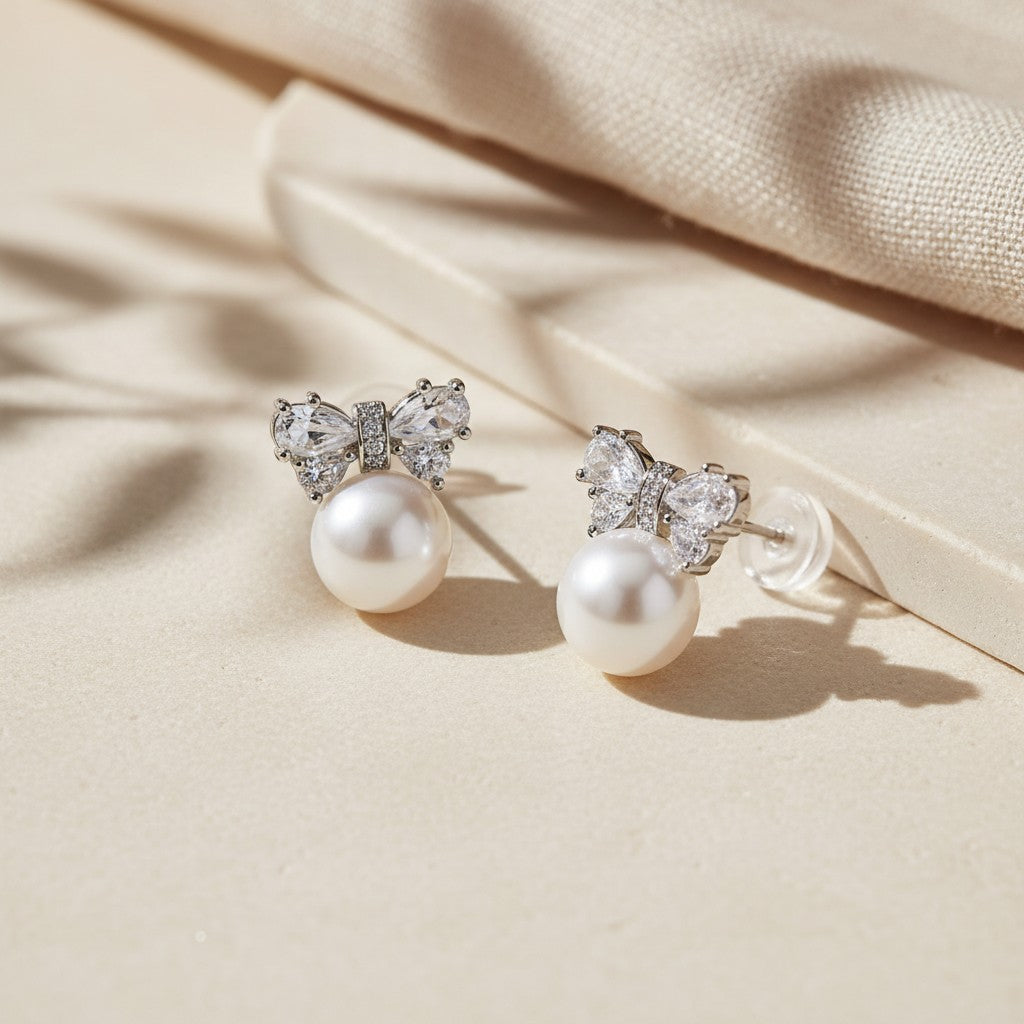 Pearl Bow stud earrings in 925 sterling silver with cubic zirconia accents and 7mm pearls staging image