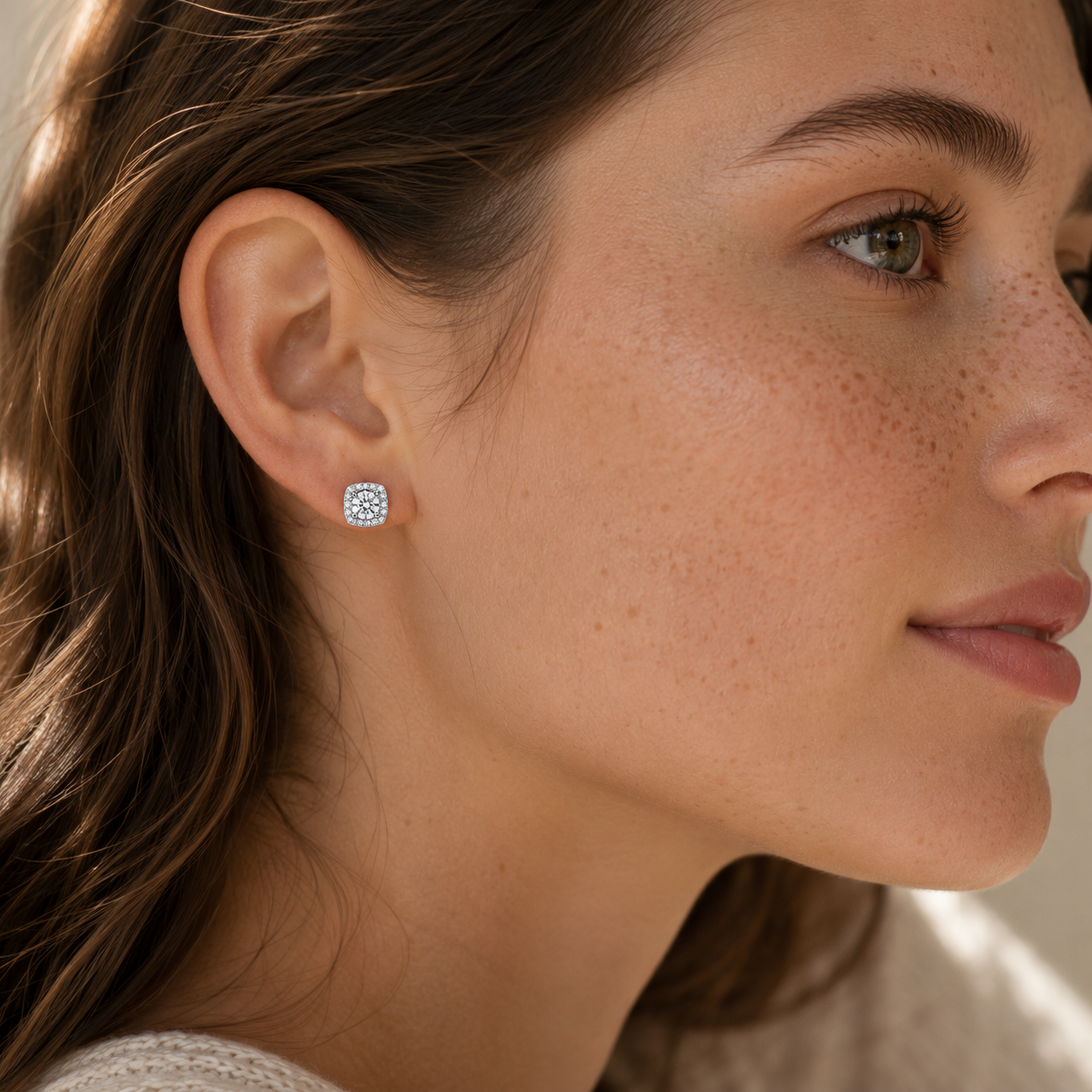 Platinum plated 925 sterling silver square halo moissanite stud earring worn on right ear