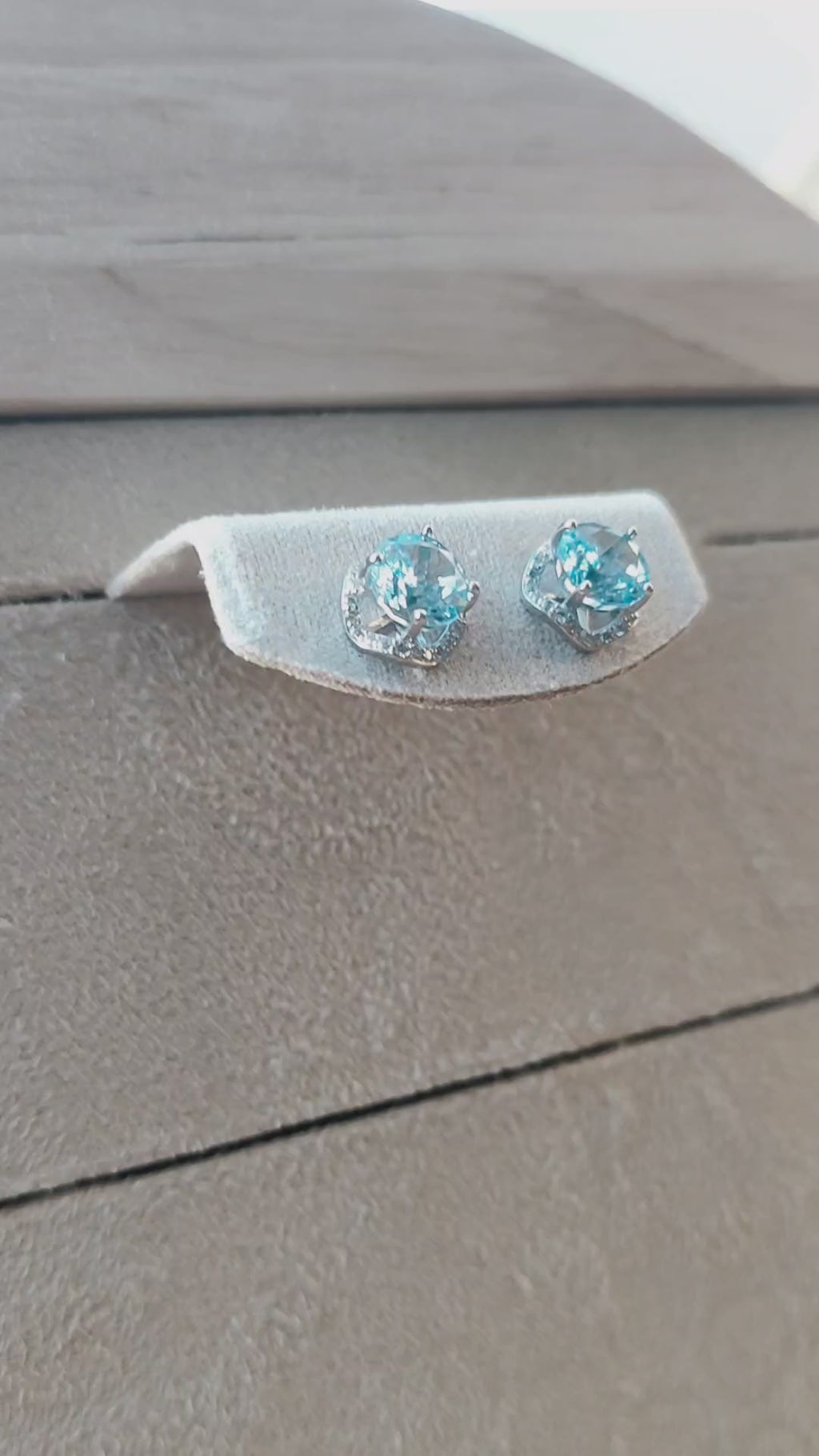 Close-up video showcasing the blue CZ snowflake-cut stud earrings and their sparkle in natural light
