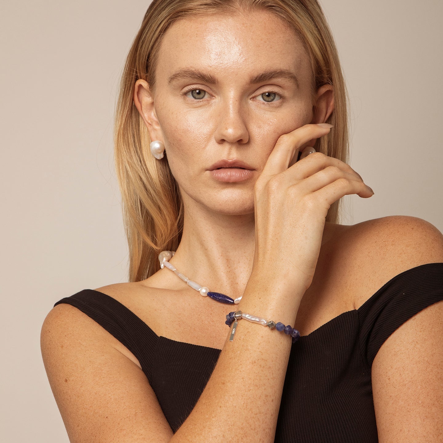 Sodalite and freshwater pearl statement bracelet styled on model with coordinating pearl jewellery