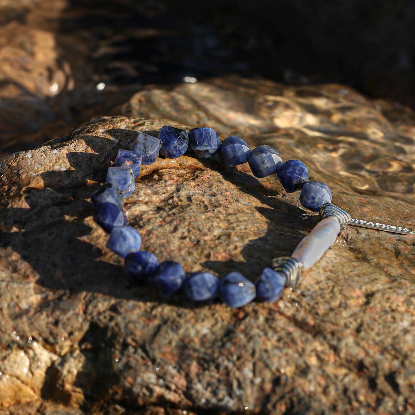 Sodalite and freshwater pearl statement bracelet styled on natural rock
