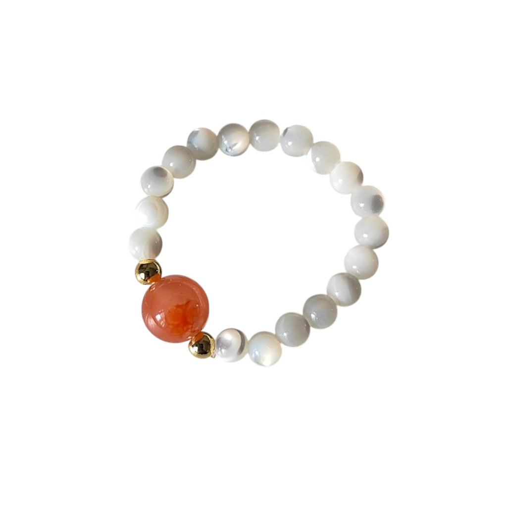Southern Red Agate & Mother of Pearl Stretch Beaded Ring featuring a polished natural Southern Red Agate focal bead, smooth Mother of Pearl round beads, and gold-tone accent beads on a comfortable elastic band.